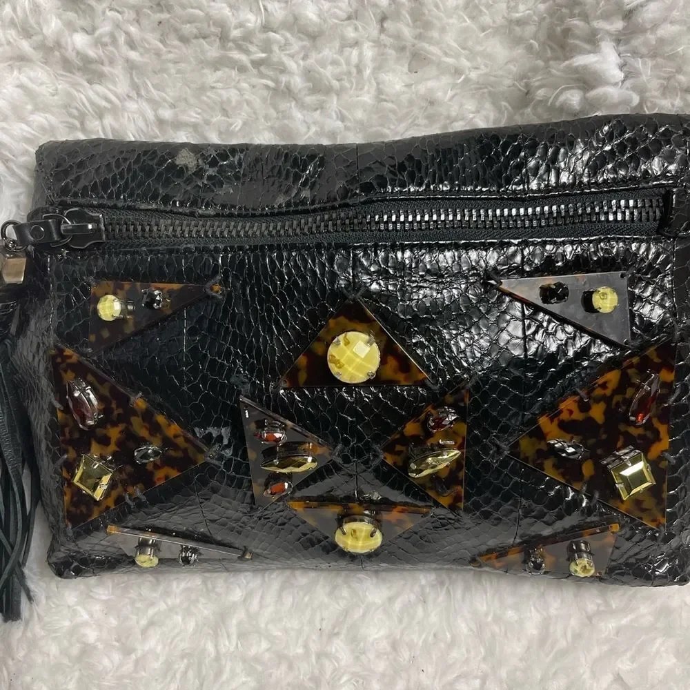 Rafe Black patent snake skin print clutch embellished with jewels and tassel .